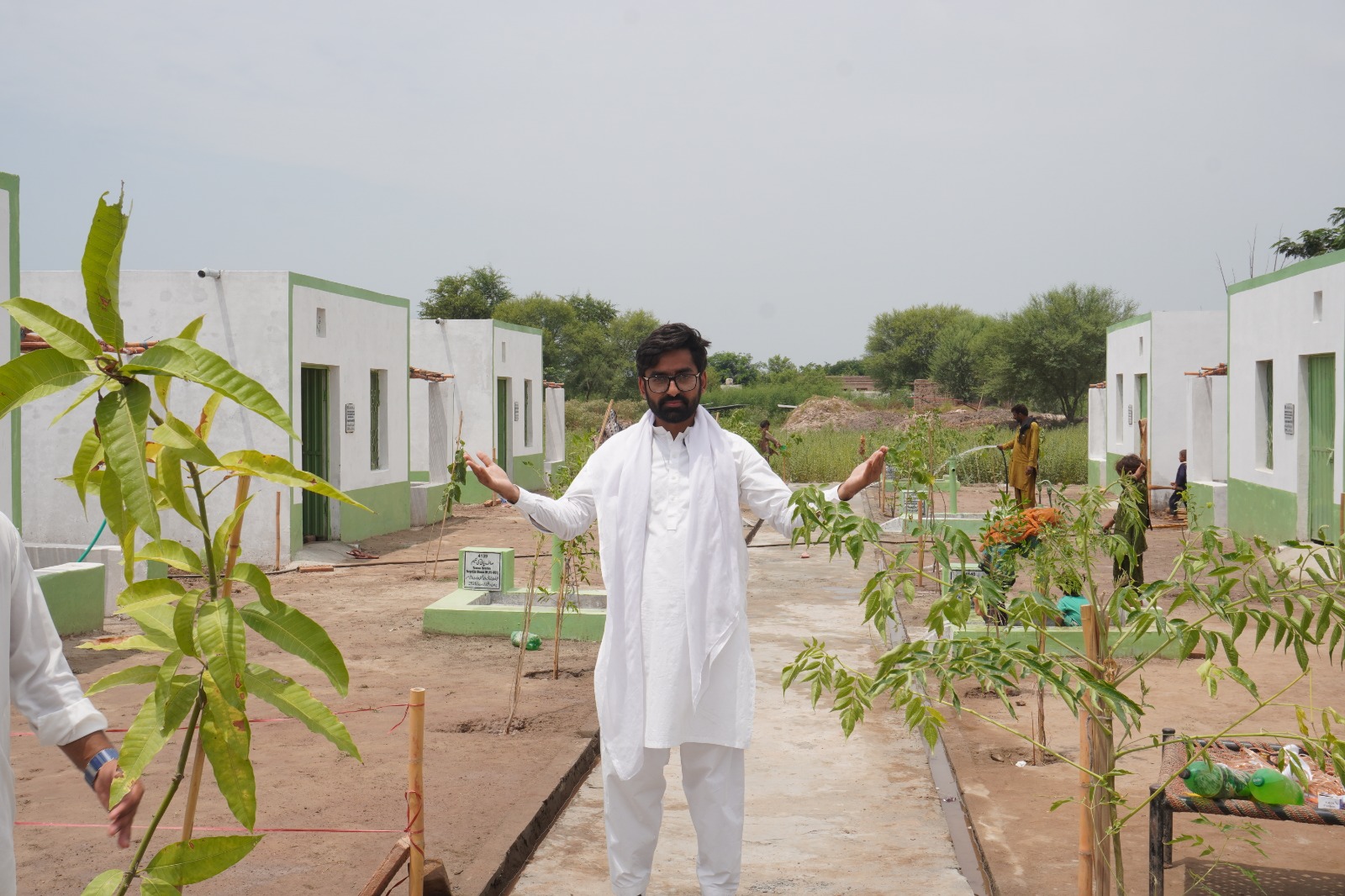 Completed homes, hand pumps and newly planted trees